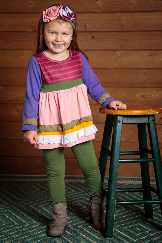Charming 2 piece girls outfit. Sizes 2T-7T. Green leggings and a pink, purple, and green flowing top. Flowered headband included.