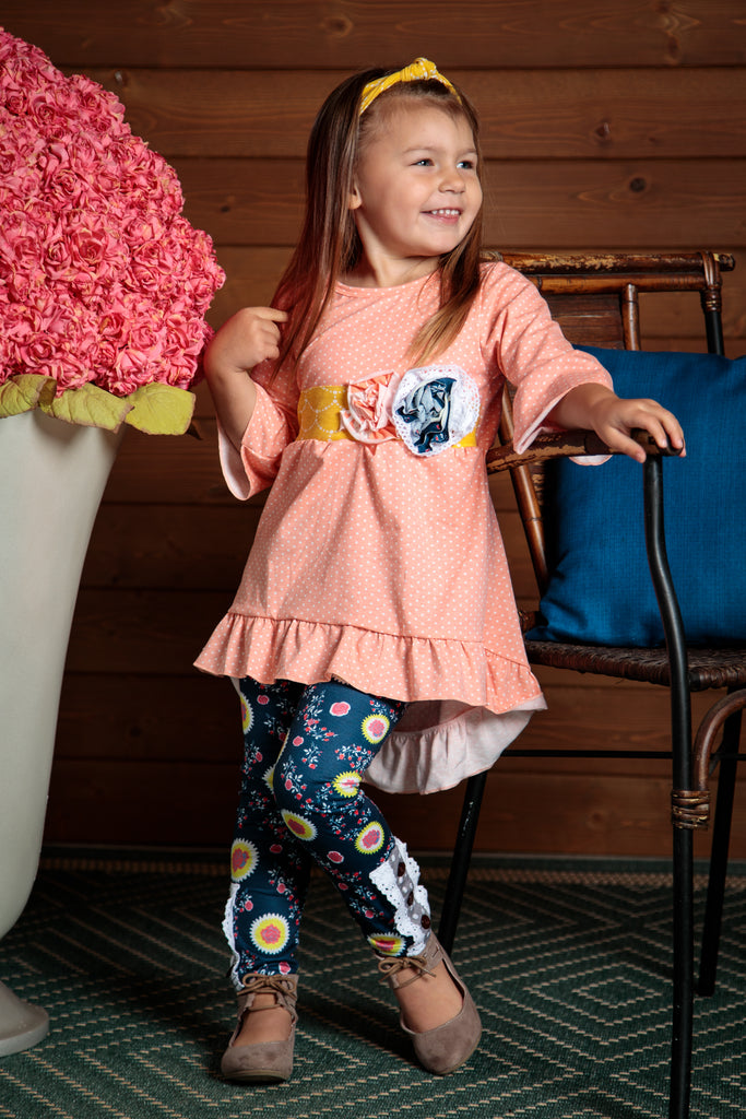 Delightful and stylish 2 piece girls outfit. Sizes 2t-7t. Leggins have button and ruffle detail and the top has flower and polka dots.